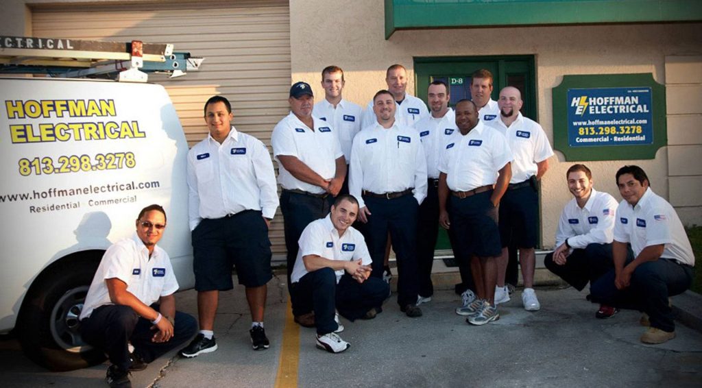 The hoffman electrical team standing together outside the office.