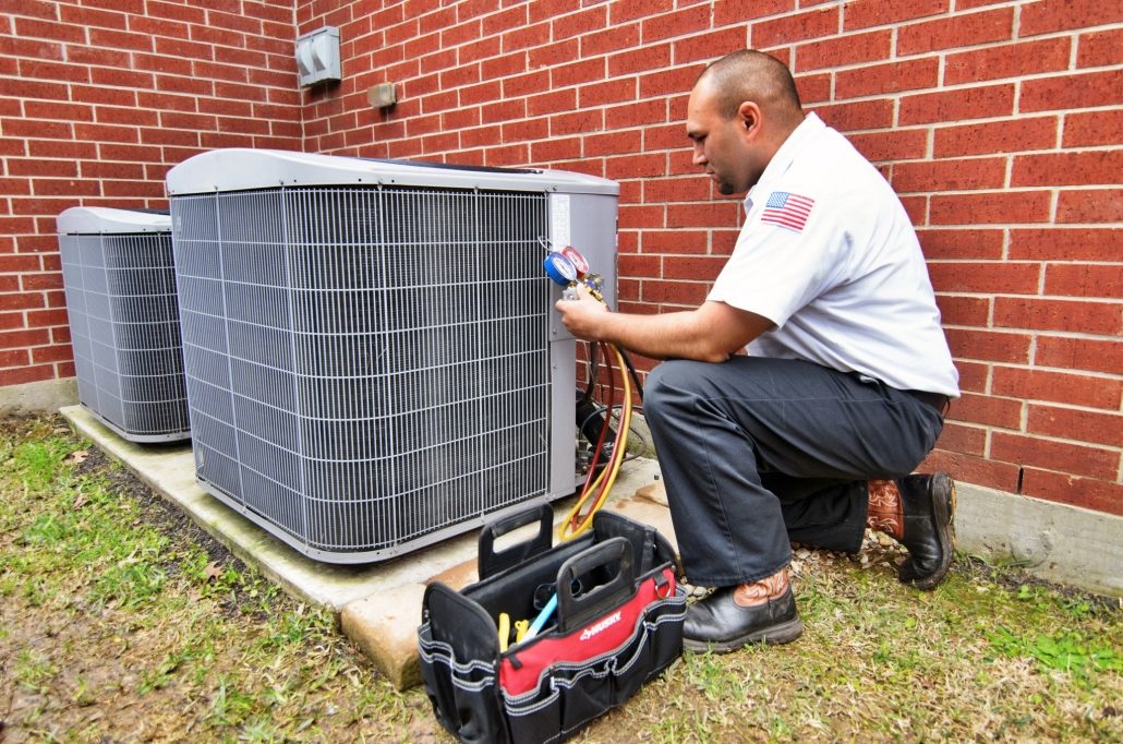 A technician inspecting an air conditioner for issues.